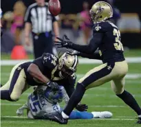  ?? Associated Press ?? New Orleans Saints defensive end Cameron Jordan (94) forces Detroit Lions running back Theo Riddick (25) to lose the football on a pass play, as Saints strong safety Kenny Vaccaro (32) intercepts in the second half of an NFL football game Oct. 15 in...