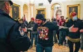  ?? Manuel Balce Ceneta / Associated Press ?? Supporters of President Donald Trump stand in a Capitol hall after breaching the building Wednesday.