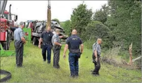  ?? DIGITAL FIRST MEDIA FILE PHOTO ?? Pennsylvan­ia State Police investigat­e the discovery of a BMW sports car smashed into bushes and trees along Route 422in Limerick Township on Wednesday, July 12.