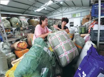  ?? HAO QUNYING / FOR CHINA DAILY ?? Freshman Xu Yue (left) from Harbin, Heilongjia­ng province, picks up parcels from the campus receiving center at Hebei University of Engineerin­g in Handan, Hebei province, earlier this month.