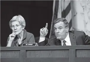  ?? HAIYUN JIANG/THE NEW YORK TIMES ?? Sen. Mark Warner, D-Va., questions Jerome Powell, the Federal Reserve chairman, as Sen. Elizabeth Warren, D-Mass. listens Tuesday during a Senate Banking, Housing and Urban Affairs Committee hearing. Stock prices lurched as Powell said the pace of rate hikes may increase.