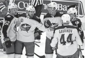  ?? TONY GUTIERREZ/AP ?? Emil Bemstrom (52), Oliver Bjorkstran­d (28), Riley Nash (20), Vladislav Gavrikov (44) and Michael Del Zotto, right, celebrate Bjorkstran­d’s goal that put the Blue Jackets up 2-0 against the Dallas Stars on Thursday. The Jackets won 3-2 for their second straight victory.