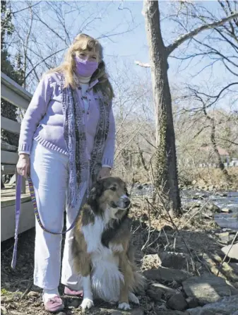  ?? BY RACHEL NEEDHAM ?? Mimi Forbes, winner of this year’s “5 Over 50” award from Aging Together, pauses for a picture beside the Thornton River in Sperryvill­e with her dog, Daisy.