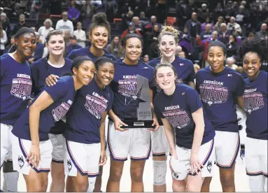  ?? Jessica Hill / Associated Press ?? The UConn women pose with the American Athletic Conference trophy at the end of their game against Houston on Saturday in Storrs.