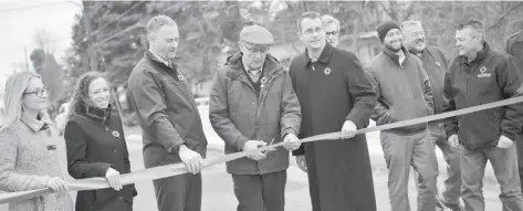  ?? [VERONICA REINER / THE OBSERVER] ?? Conservati­ve MPPs, Wellesley council members and the minster of infrastruc­ture all gathered on November 8 to celebrate the finished constructi­on of Bridge 26 on Nafziger Road. Here, Wellesley Mayor Joe Nowak (centre) cuts the ribbon.