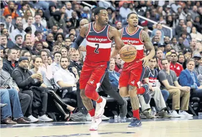  ?? ROB CARR/GETTY IMAGES FILE PHOTO ?? John Wall, left, missed all four regular-season games against the Raptors and Bradley Beal shined brightest while seeing Raptor red.