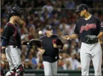  ?? WINSLOW TOWNSON — THE ASSOCIATED PRESS ?? Indians starting pitcher Carlos Carrasco tosses the ball to catcher Yan Gomes as pitching coach Carl Willis heads for the mound during the fourth inning.
