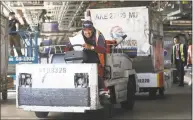  ?? Liz Hafalia / The San Francisco Chronicle ?? Ramp agent Victor Carrero drives baggage containers in San Francisco. Average hourly earnings for private workers increased 2.9 percent in August from a year earlier, the most since the recession ended in mid- 2009.