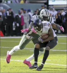  ?? THE ASSOCIATED PRESS ?? Jets middle linebacker David Harris (52) tackles Ravens wide receiver Mike Wallace (17) Sunday in East Rutherford.