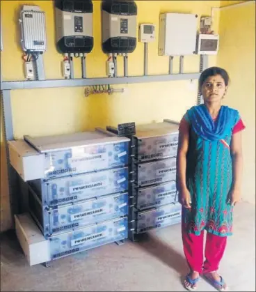  ?? GAYATRI JAYARAMAN/HT ?? 21yearold Manisha Anand Tawad from Tundepada manages the fencedin solar microgrid for her hamlet.