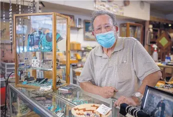  ??  ?? ABOVE: Joe Madrid works at a jewelry counter in his shop, Apache Trading Co., in Ruidoso.