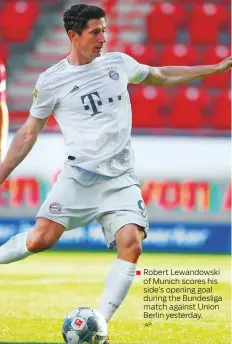  ?? AP ?? Robert Lewandowsk­i
■ of Munich scores his side’s opening goal during the Bundesliga match against Union Berlin yesterday.