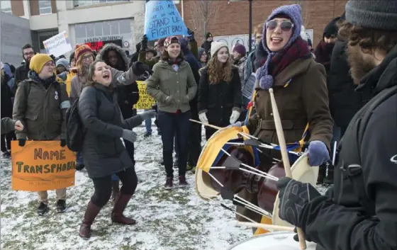  ?? MATHEW MCCARTHY, RECORD STAFF ?? Janice Jo Lee, right, leads the drumming at a trans solidarity rally at Wilfrid Laurier University on Thursday.