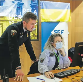  ?? ?? Ukrainian SEF inspector Vladyslav Martynyuk (left) is assisting Ukrainian passengers arriving at Lisbon’s Humberto Delgado Airport