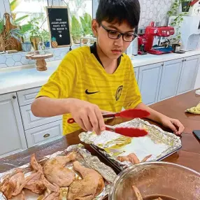  ??  ?? Encouraged that his sticky chicken wings turned out good, aiden is keen to try out more recipes.