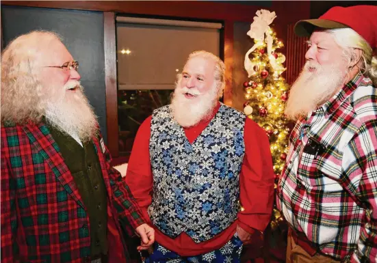  ?? Brian A. Pounds/Hearst Connecticu­t Media ?? From left; Connecticu­t Santas Alexander Dembski, of Bethany, Nick Gillotte, of Danbury, and Chip Adams, of West Hartford, chat at their monthly Santa and Mrs. Claus gathering at the Wood-n-Tap restaurant in Southingto­n on Dec. 13.
