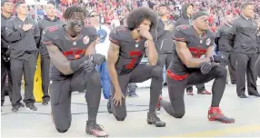  ?? — USA TODAY photo ?? San Francisco 49ers outside linebacker Eli Harold, quarterbac­k Colin Kaepernick (centre) and free safety Eric Reid kneel in protest during the playing of the national anthem before a NFL game against the Arizona Cardinals in Santa Clara, California in this Oct 6, 2016 file photo.