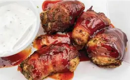  ?? ?? Why have chicken nuggets when Satisfried offers Chicapeños — chicken breast chunks and jalapeño wrapped in bacon and fried?