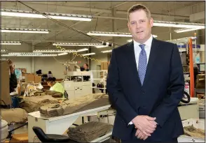  ?? Arkansas Democrat-Gazette/SEAN CLANCY ?? Reed Gibbons stands near clothing made by blind and visually impaired workers at IFB Solutions in Little Rock. Gibbons serves on the Advisory Council and the Bingo for Bags committee, which benefits IFB Solutions.