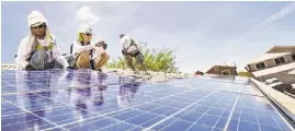  ?? MICHAEL SCHENNUM/REPUBLIC ?? SolarCity’s Tinh Nguyen (from left), Dylan Robins and Michael Armin install solar panels on a Cave Creek home. APS seeks to trim customers’ solar credits.