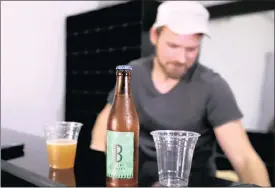  ?? PHOTO: REUTERS ?? Kelvin Conroy, co-founder of the Bature brewery, stands behind a bottle of Bature beer on the front desk at the Bature brewery in Abuja, Nigeria. Nigerians drink 16 million hectolitre­s of beer a year. Bature is a well-received addition.