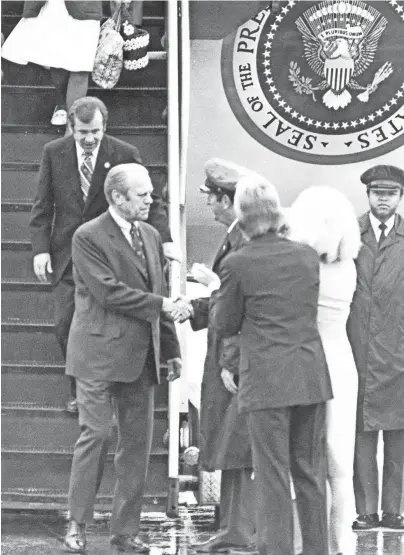  ?? THE COMMERCIAL APPEAL ?? President Gerald Ford, followed by Sen. Howard Baker, R-tenn., is greeted upon his arrival in Memphis on May 14, 1976. The president spoke at the dedication of Mid-america Mall during his visit.