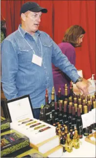  ??  ?? Ronald McDaniel explains the health benefits of olive oils offered at the Strippaggi­o booth.