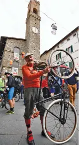  ?? — AFP ?? (Left) Italian Luciano Berruti with his old bike on the eve of ‘Eroica Montalcino’ festive event in Montalcino, Tuscany, on Saturday. L’Eroica Montalcino is a cycling leisure ride along white roads that follow part of the 209-km L’Eroica route, south...