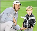  ?? HARRY HOW / GETTY IMAGES GOLF PGA TOUR ?? Dustin Johnson shows offff his trophy with son Tatum after his victory at the Genesis Open. The Juno Beach resident went 49 straight holes without a bogey.