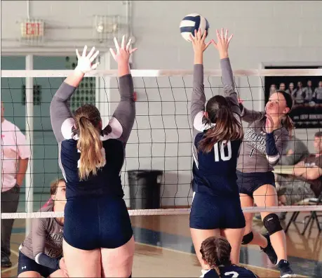  ??  ?? Tori Hall looks to put a kill between two Andrew College defenders as Kayleigh Goff looks on. The Lady Bobcats rallied from a 2-1 deficit to win in five sets. (Photo by Scott Herpst)