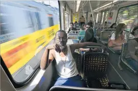  ?? Mel Melcon Los Angeles Times ?? JULES WATKINS rides an Expo Line train last year. Analysts say a plan to build near five Metro stations could add 14,300 jobs and 6,000 apartments and condos.