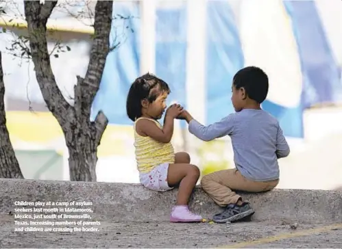  ??  ?? Children play at a camp of asylum seekers last month in Matamoros, Mexico, just south of Brownsvill­e, Texas. Increasing numbers of parents and children are crossing the border.