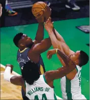  ?? CHARLES KRUPA — THE ASSOCIATED PRESS ?? The Pelicans’ Zion Williamson, left, drives to the basket against the Celtics during Monday’s game.