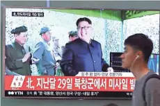  ?? ASSOCIATED PRESS ?? A man at the Seoul Railway Station in Seoul, South Korea, on Sunday passes by a TV news story on the firing of a North Korean missile.