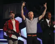  ?? (Fred Thornhill/Reuters) ?? RYAN LEWIS (left) and Macklemore (center) attend the 2016 iHeartRadi­o Much Music Video Awards in Toronto.