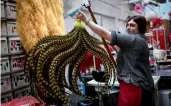  ?? — AFP ?? A seamstress works in the Fevrier House feathers workshop at The Moulin Rouge Cabaret in Paris on Tuesday.