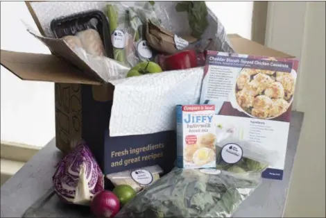  ?? MATTHEW MEAD — THE ASSOCIATED PRESS FILE ?? In this file photo, an example of a home delivered meal from Blue Apron seen in Concord, N.H. Despite the old saying, you can buy happiness, especially if you spend it to save yourself time, new research finds.Researcher­s surveyed more than 6,000...