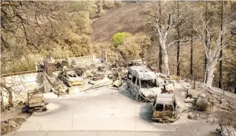  ?? — AFP photo ?? A burned residence is seen during the LNU Lightning Complex fire in Vacaville, California.