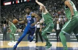  ?? SIMON COOPER — PA VIA AP ?? The 76ers’ Joel Embiid, left, tries to drive on the Celtics’ Aron Bynes Thursday at the O2 Arena in London.