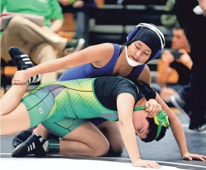  ?? RICK WOOD / MILWAUKEE JOURNAL SENTINEL ?? Natalia Ramirez of Milwaukee Reagan (top) wrestles Sophia Diaz of Milwaukee Hamilton during a 120- to 126-pound match at the Bauer Brawl tournament at West Allis Hale High School. See more photos and a video at jsonline.com/news.