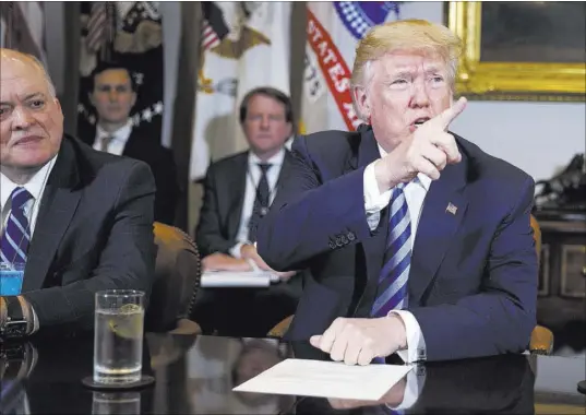  ?? Evan Vucci The Associated Press ?? Ford CEO James Hackett listens as President Donald Trump speaks during a meeting Friday with automotive executives in the Roosevelt Room of the White House.