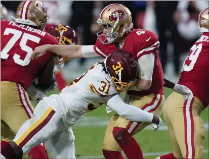  ?? ROSS D. FRANKLIN — THE ASSOCIATED PRESS ?? 49ers quarterbac­k Nick Mullens takes a hit after the throw by Washington safety Kamren Curl during the first half of Sunday’s game.