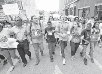  ?? Karen Warren / Houston Chronicle ?? The March for Our Lives protest two weeks ago included 10-year-old Dezmond Floyd of Humble, center, as area students rallied in support of the national movement.