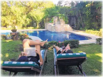  ?? MARJORIE MILLER/THE ASSOCIATED PRESS ?? People relax by the pool in the yard of their Airbnb rental in Cozumel, Mexico. Listings and reviews on Airbnb can only tell so much. Knowing how to read pictures can reveal even more about a space.