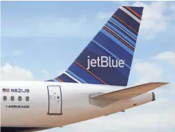  ?? AFP/GETTY IMAGES ?? A JetBlue A320 is parked at Airbus' assembly line in Mobile, Ala.