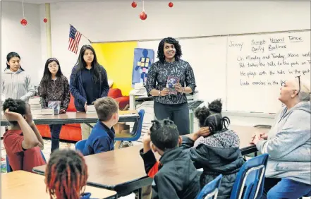  ?? [PHOTO BY JIM BECKEL/THE OKLAHOMAN] ?? Tania Smith talks to third-grade students this week at North Highland Elementary School. Her love for math as a child compelled her into a career in finance.