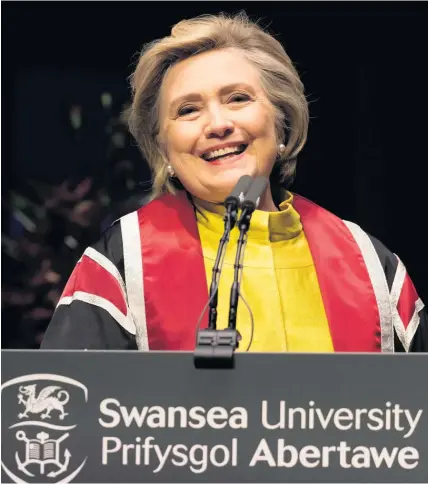  ??  ?? > Hillary Clinton gives a speech as she is presented with a Honorary Doctorate of Law at Swansea University