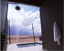  ??  ?? TOP LEFT A constant play between light and shadow unfurls in the Namib Desert.TOP RIGHT Sundowners in bed is an option, as all rooms face west. ABOVE LEFT There’s interestin­g decor and attention to detail. ABOVE RIGHT Each bungalow has an outdoor shower and a deck with a pool.