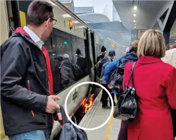  ??  ?? Panic station: Passengers leave the train as its brakes catch alight yesterday