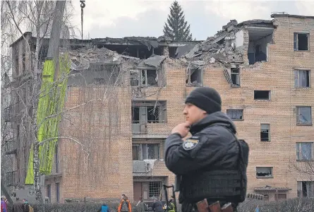  ?? EFREM LUKATSKY/ AP ?? A police officer guards the scene of a drone attack Wednesday in Rzhyshchiv, Ukraine. The attack on a high school came hours after Chinese President Xi Jinping wrapped up what he called a mission of peace to Moscow.